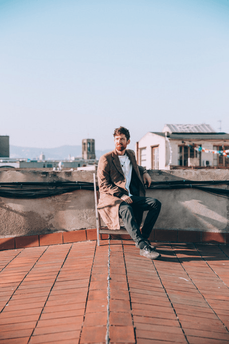 Team member portrait, sitting on a rooftop